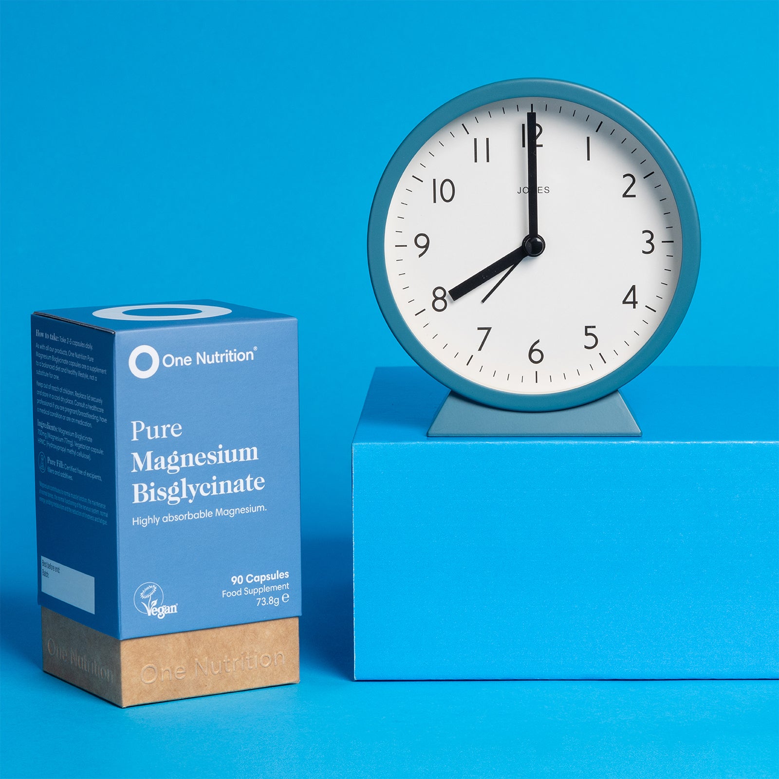 One Nutrition Pure Magnesium Bisglycinate supplement box with a clock on a blue background