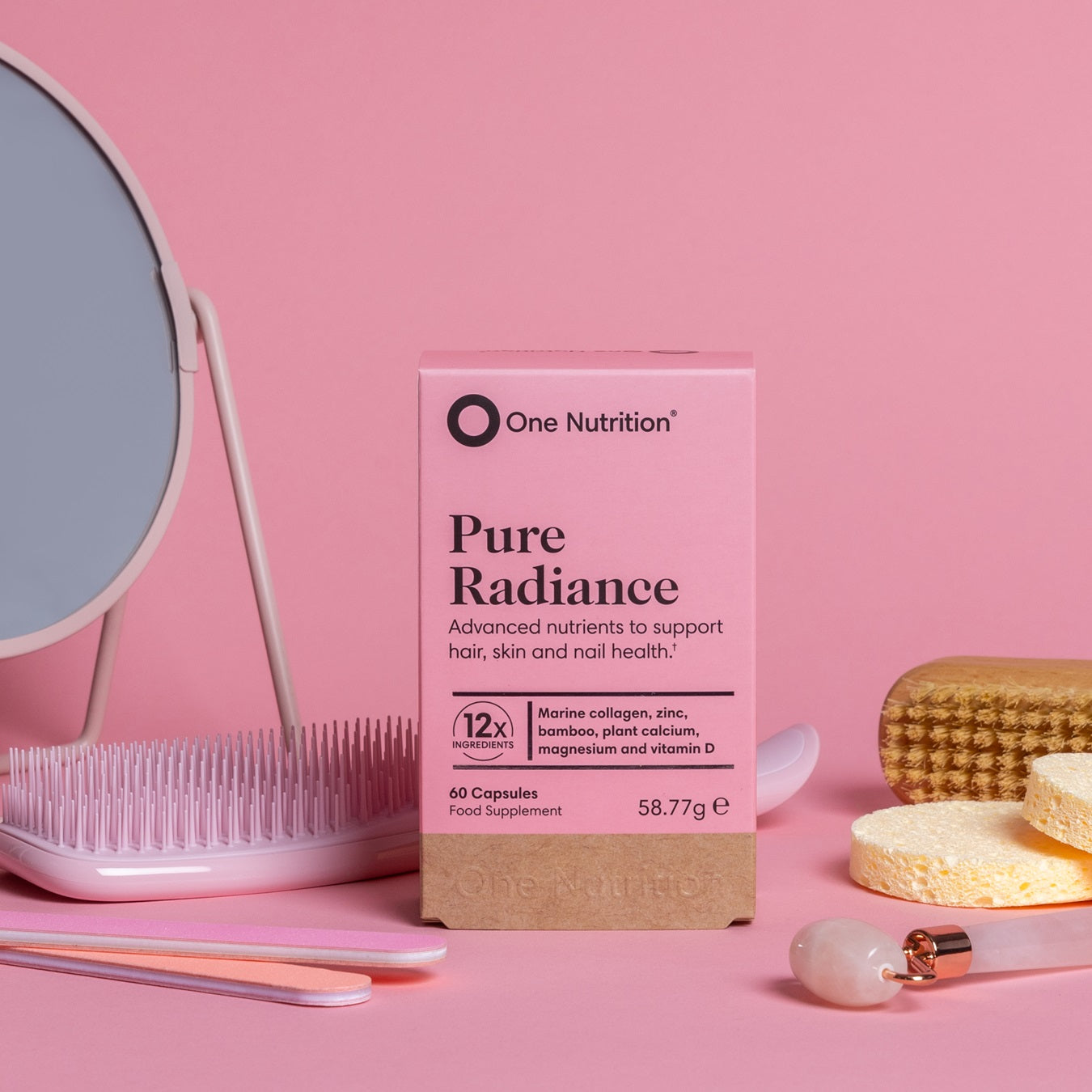 One Nutrition Pure Radiance supplement box on a pink background with a mirror and skincare items.